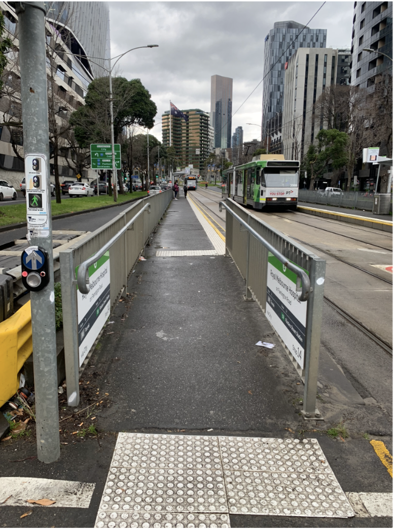 Image description: Photo of ramp leading down onto Flemington Road from Royal Melbourne Hospital 14 tram stop.